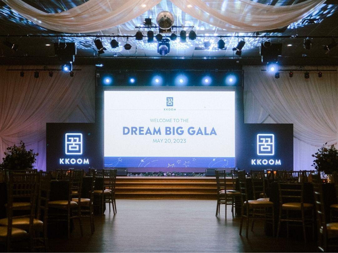 Dream Big Gala stage with KKOOM branding prepared for the fundraising event.