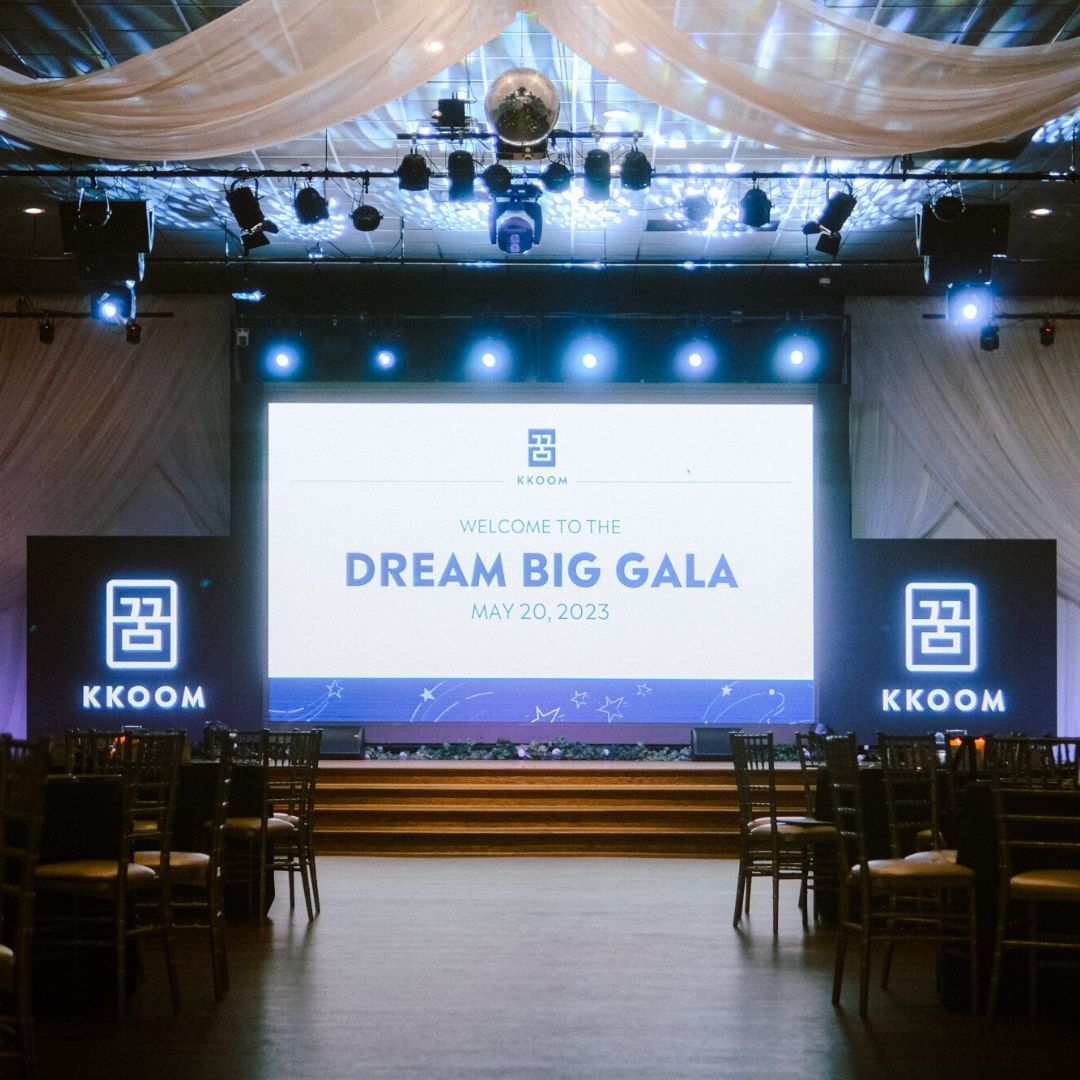Dream Big Gala stage with KKOOM branding prepared for the fundraising event.