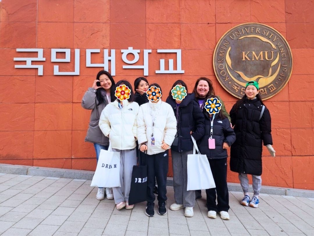 GEM Program volunteers and students standing together in front of a university building.
