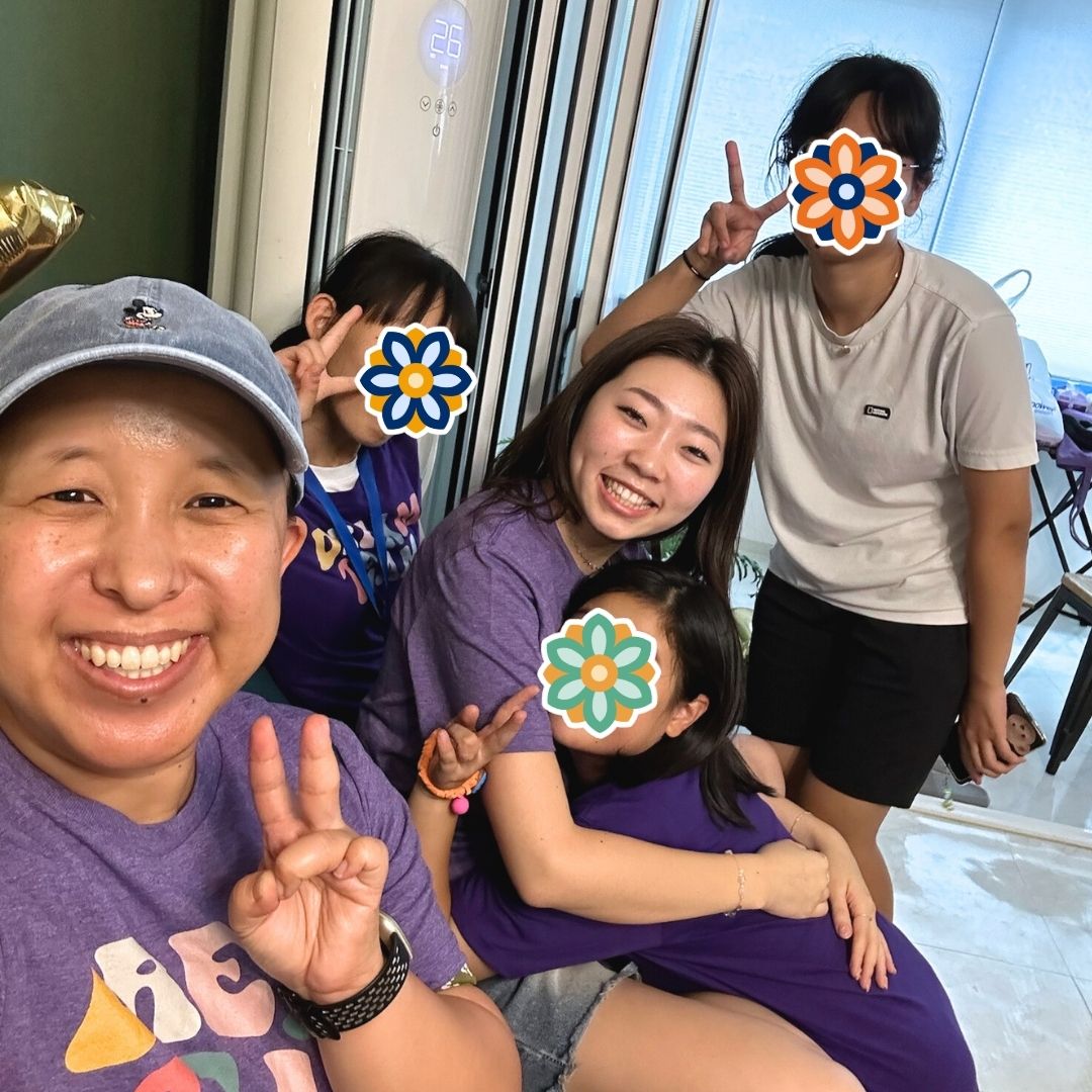 KKOOM staff and GEM Program students smiling and relaxing together after a group activity.