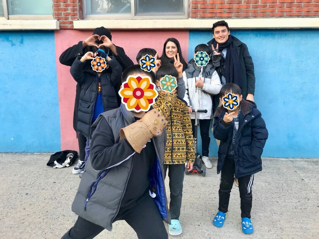 Group of children and volunteers posing together outside a children’s home in Korea.