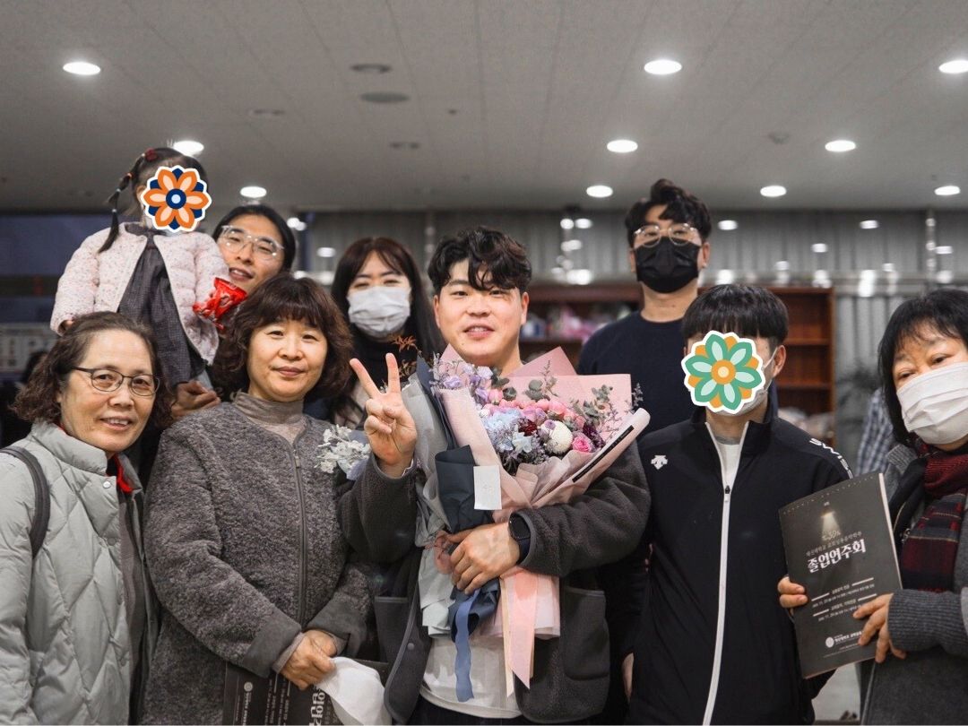 Students and staff celebrating a graduation together.